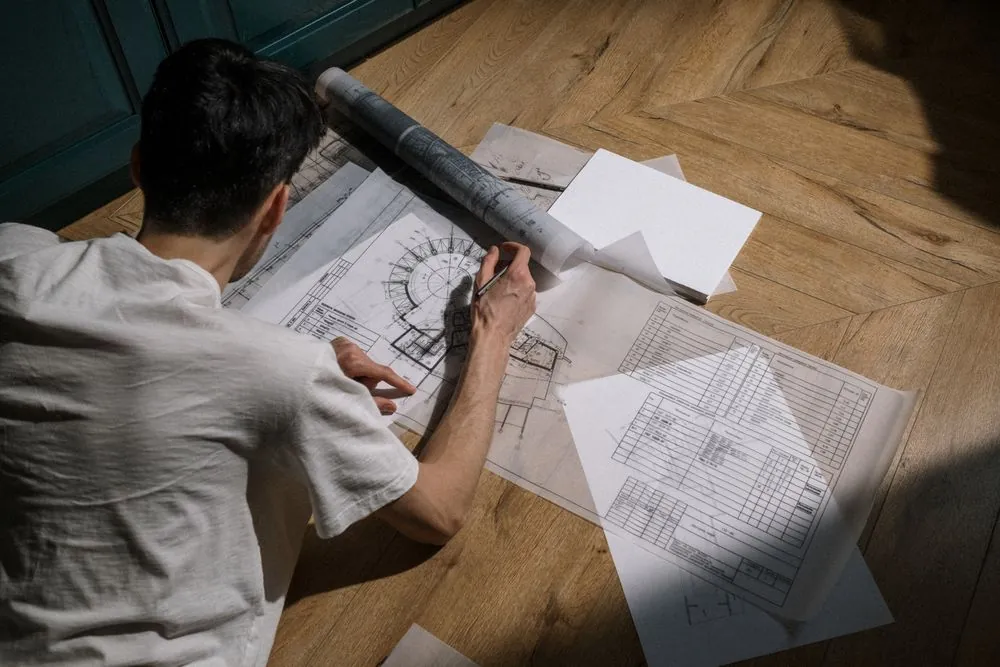 A designer drawing a garden plan by hand
